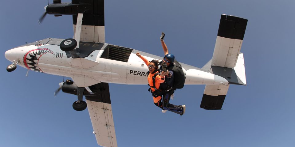 skydiving vs BASE jumping two tandem skydivers smile as they enter into freefall