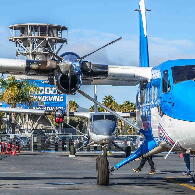 Airplane in front of indoor skydiving tunnel at Skydive Perris