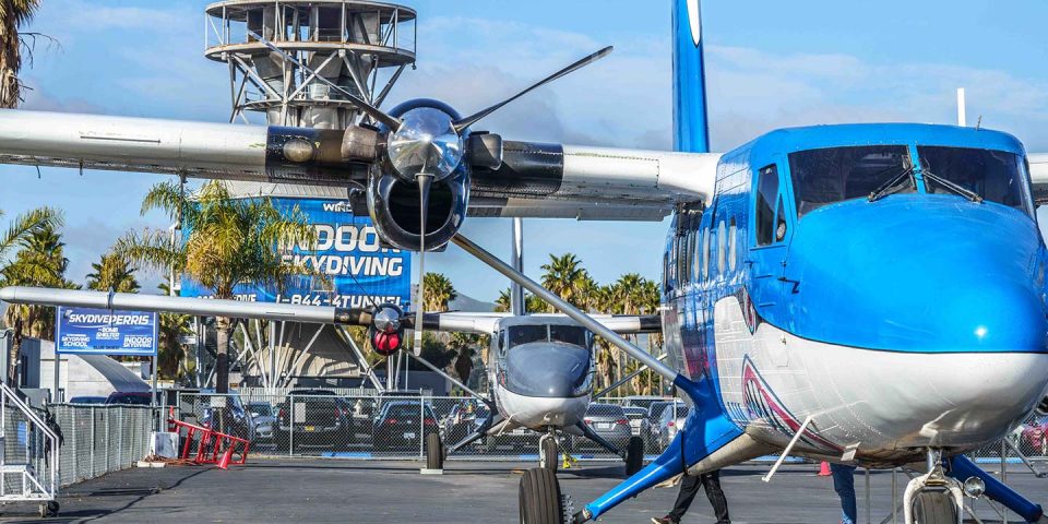 Airplane in front of indoor skydiving tunnel at Skydive Perris
