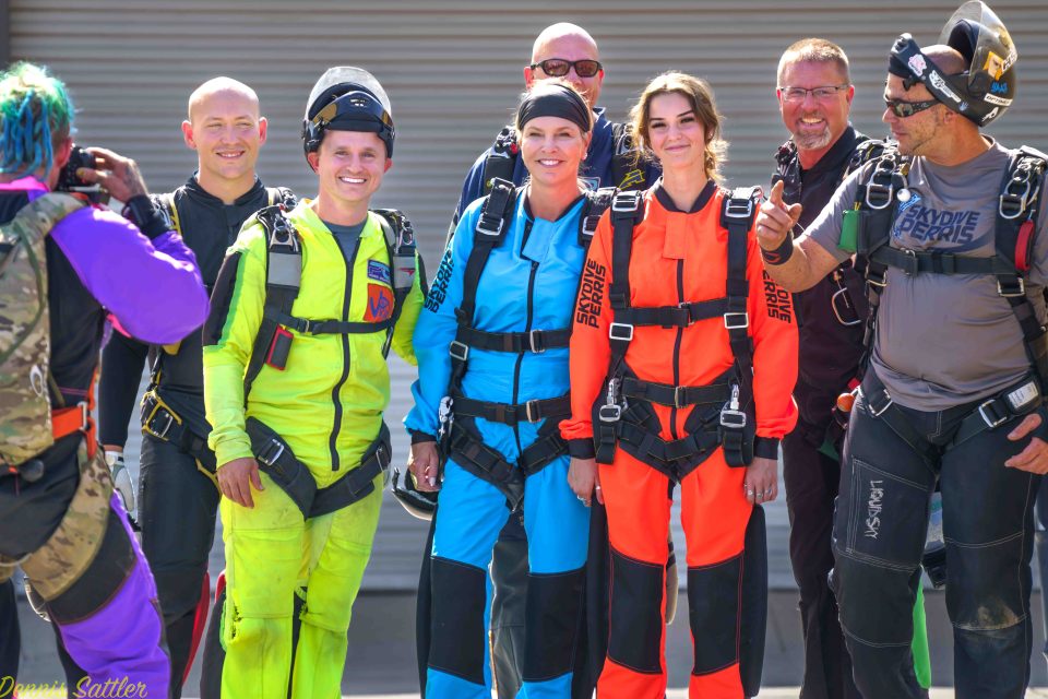 Happy group of tandem students with vivid jumpsuits
