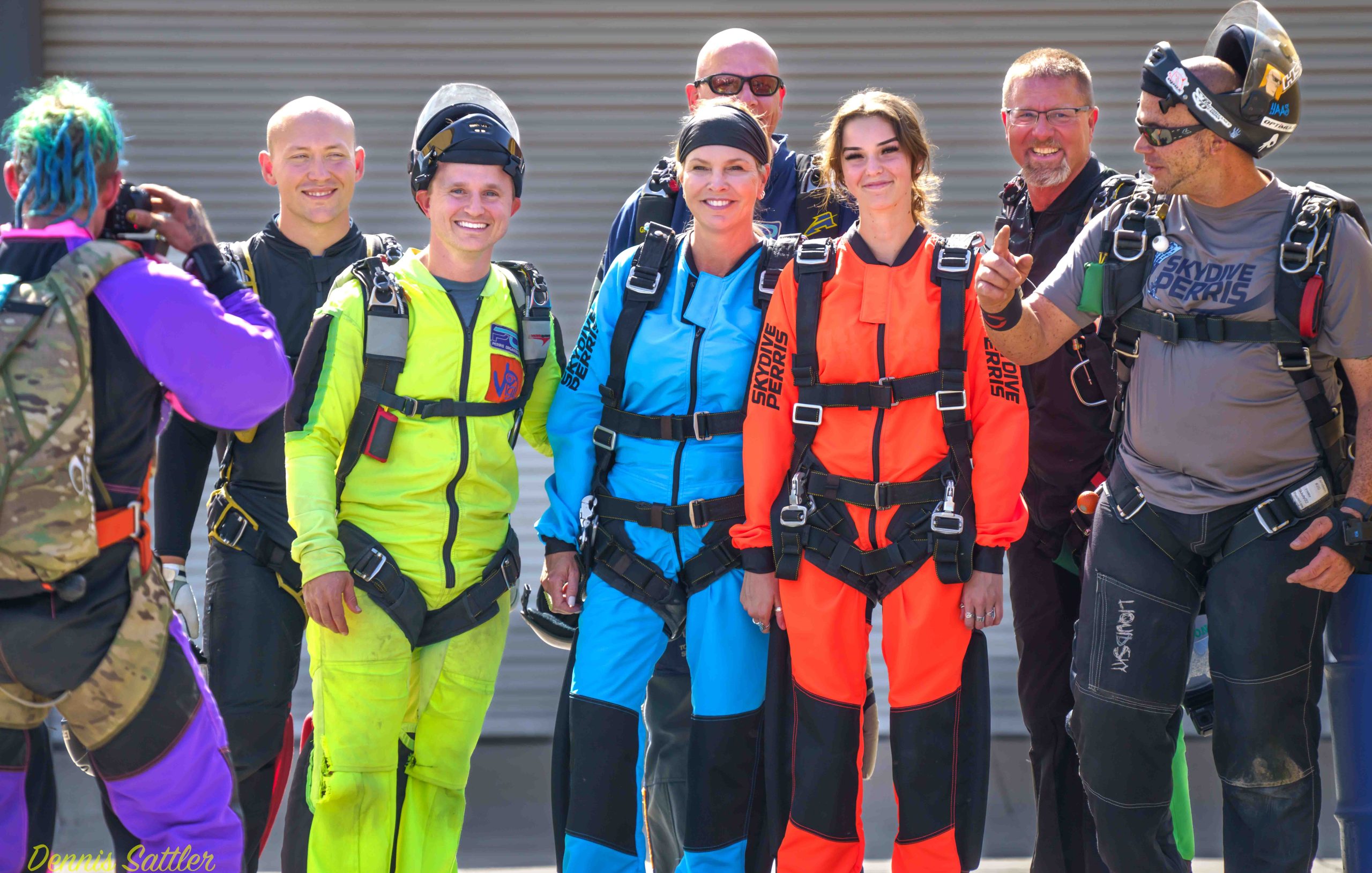 Happy group of tandem students with vivid jumpsuits