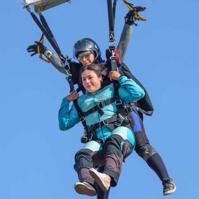 Tandem skydivers coming in for landing