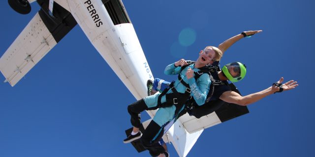 tandem skydivers exiting airplane over Skydive Perris near skydiving in San Diego