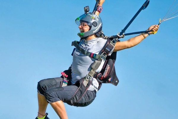Katie Piele under canopy against a blue sky