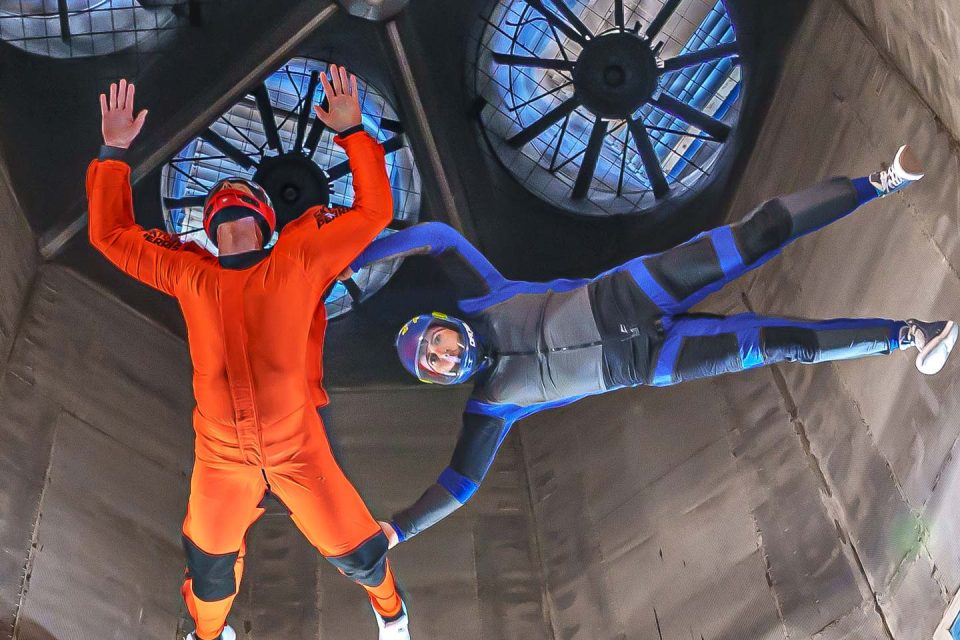 an instructor and student fly high in the tunnel at Skydive Perris