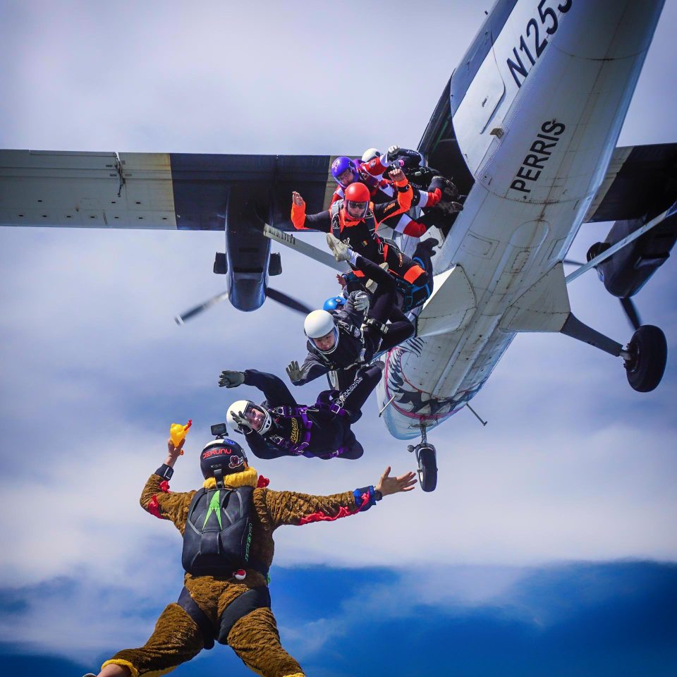 skydivers exit airplane