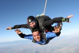 can you pass out while skydiving? tandem skydivers smiling in freefall