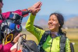 tandem skydiving student gives high five after landing
