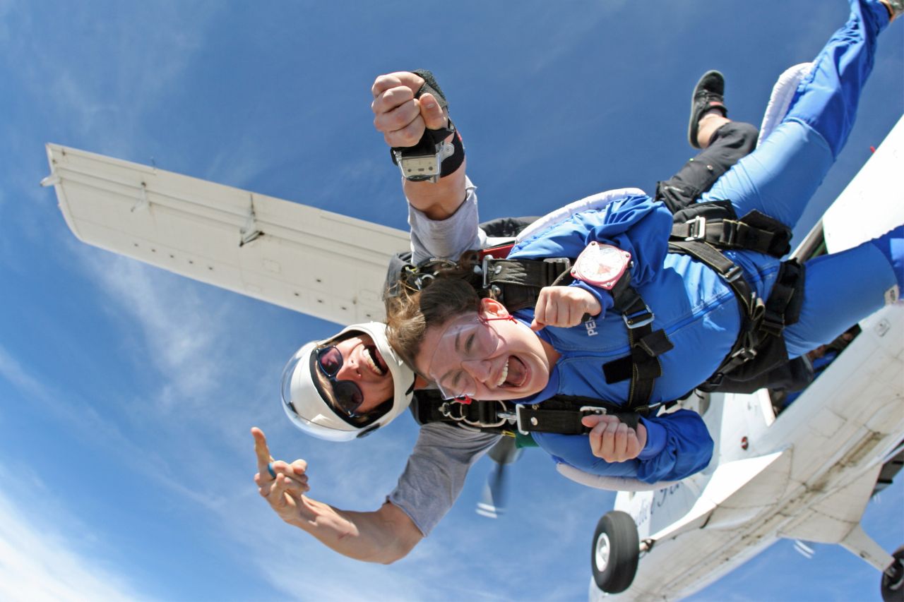 Tandem skydivers exiting airplane 