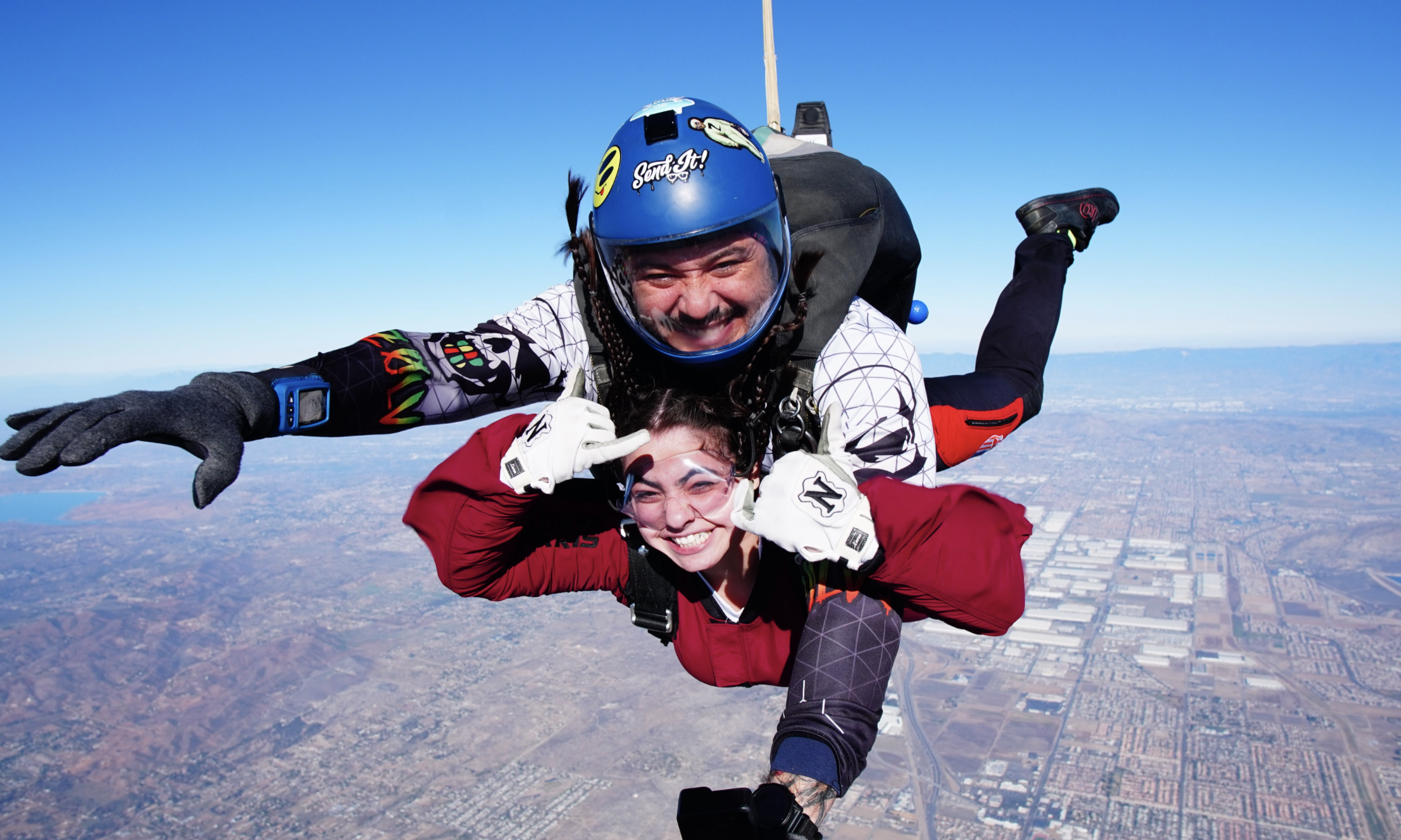 tandem skydivers look excited and happy during freefall