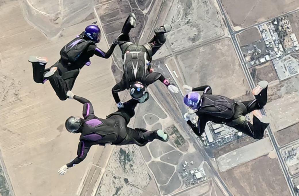 4 way skydivers in a belly formation